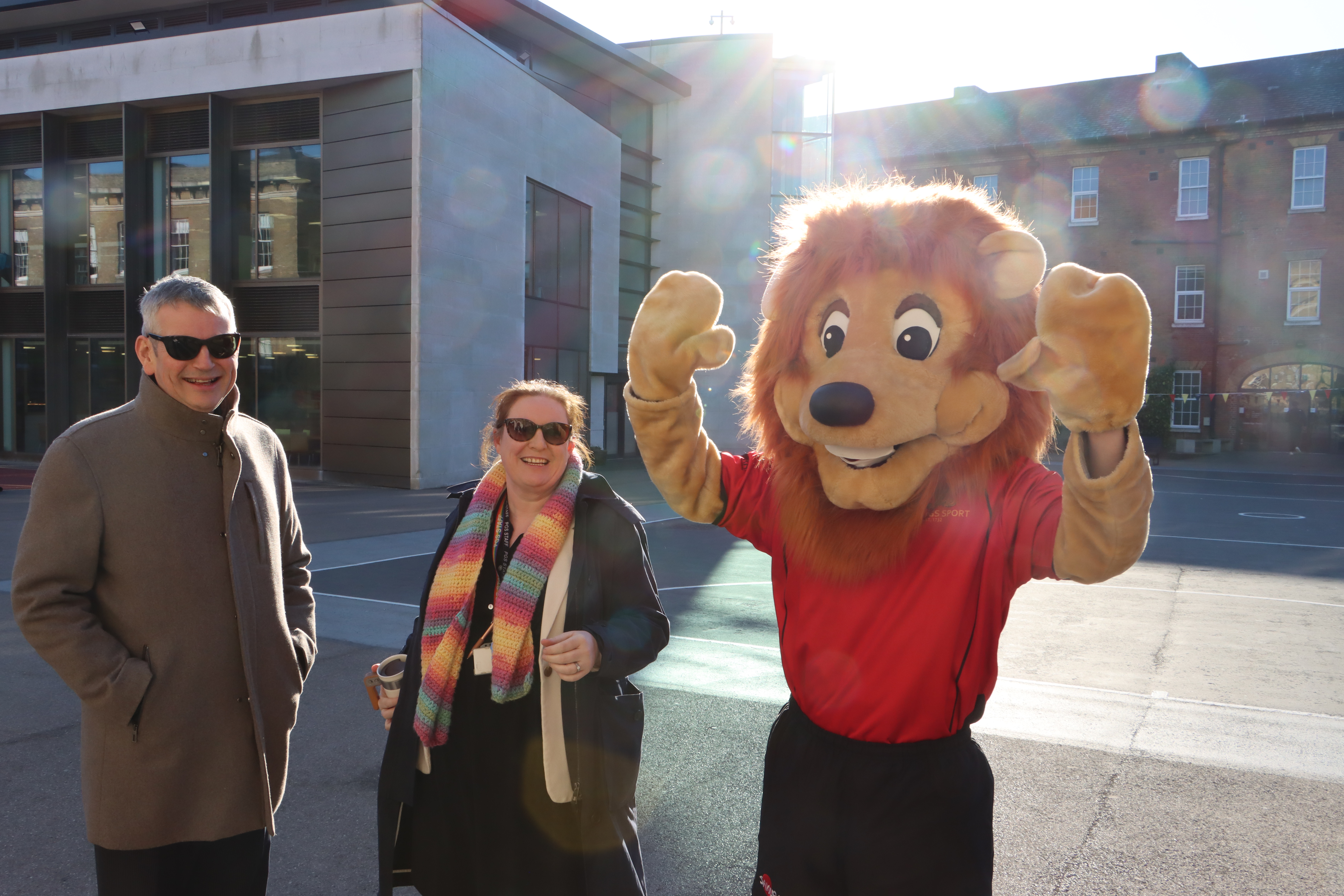 Mr David Doyle and Ms Nicola Neil, welcome pupils to school along side the PGS Lion (Mr Oliver Nolan-Davies)